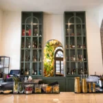 Bar with liquor bottles, wine, and garnishes in hotel lobby