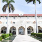 Exterior of hotel, white facade and palm trees