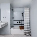 modern minimalist bathroom shower and sink in hotel suite